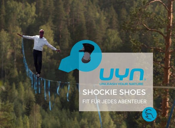 uyn-shockie-shoes-1 Fotomontage-Thomas balanciert mit shookie shoes auf einem Seil über einer Schlucht